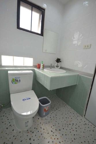 a bathroom with a toilet and a sink at 57 Hidden House BKK Chinatown in Bangkok
