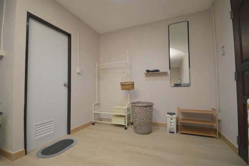 a room with a large door and a mirror at 57 Hidden House BKK Chinatown in Bangkok