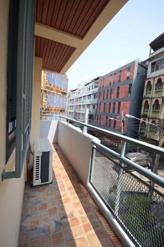 a balcony of a building with a bench on it at 57 Hidden House BKK Chinatown in Bangkok