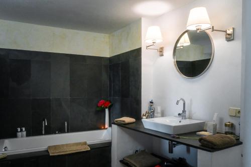 a bathroom with a sink and a mirror at Can Serola in Sales del Llierca