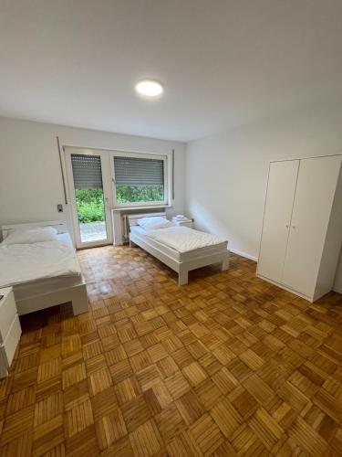 a bedroom with two beds and a wooden floor at Ferienwohnung in Amstetten in Amstetten