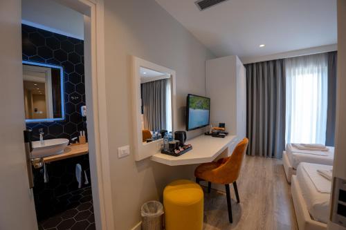 a hotel room with a sink and a bathroom at Hotel Teuta in Sarandë