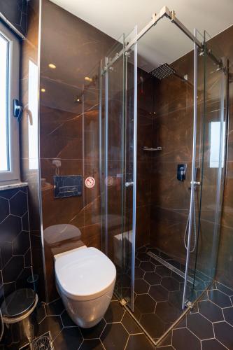 a bathroom with a toilet and a shower at Hotel Teuta in Sarandë