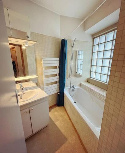 a bathroom with a tub and a sink and a bath tub at Soul La Meije - Simple, Original in La Grave