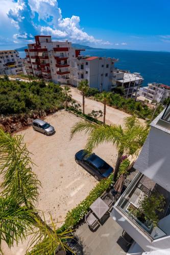 an aerial view of a sandy beach with palm trees at Hotel Teuta in Sarandë