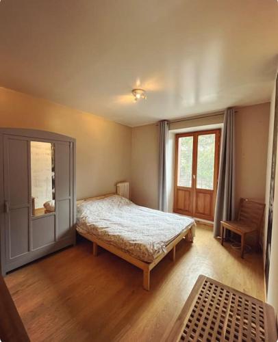 a bedroom with a bed and a window at Soul La Meije - Simple, Original in La Grave