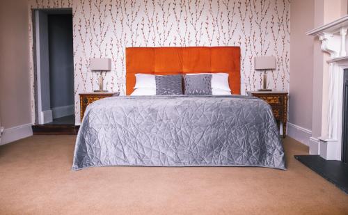 a bedroom with a large bed and two night stands at Castle Dargan Hotel in Sligo