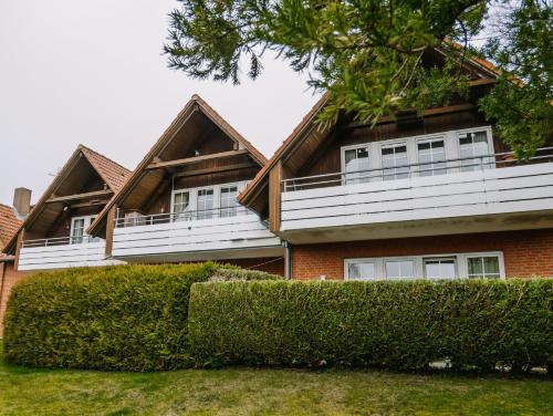a house with white balconies on top of it at Steilufer Appartments in Timmendorfer Strand