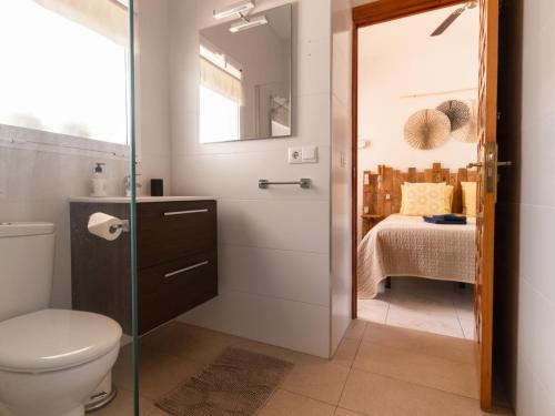 a bathroom with a shower and a toilet and a bedroom at La Casa del Burro in Nerja