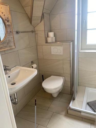 a small bathroom with a toilet and a sink at Steilufer Appartments in Timmendorfer Strand