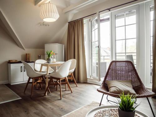 a kitchen and dining room with a table and chairs at Steilufer Appartments in Timmendorfer Strand