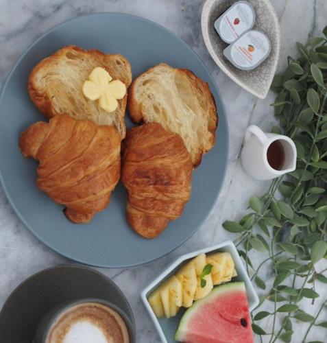 een blauw bord met drie croissants en een kopje koffie bij Villa 3 Bedrooms with private pool at Wings Pasak in Bang Tao Beach