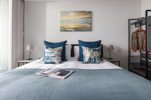 a bedroom with a bed with a book on it at St Michaels The Liner in Falmouth
