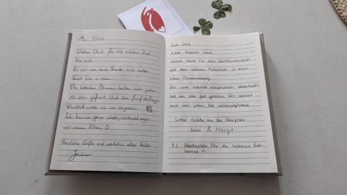 an open book with writing on it on a table at Kleiner Fuchs in Wolframs-Eschenbach