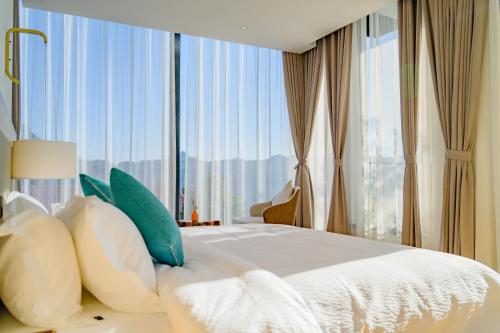 a bedroom with a large bed with a large window at XMAN Sunrise Peaks Resort--Free Pick-up in Zhangjiajie