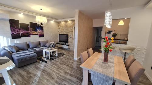 a living room with a couch and a table at New Moment in Žarkovo