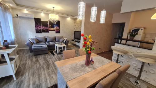 a living room with a table and a couch at New Moment in Žarkovo