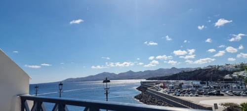 a view of the ocean from a balcony at Lanzarote Apartment Rental Harbour View in Tías
