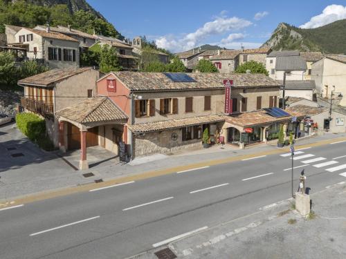 an empty street in a small town with buildings at Le relais du becassier in Annot