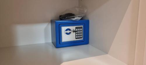 a blue alarm clock sitting on a white wall at Lanzarote Apartment Rental Harbour View in Tías