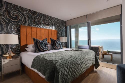 a bedroom with a bed with a view of the ocean at St Michaels The Liner in Falmouth