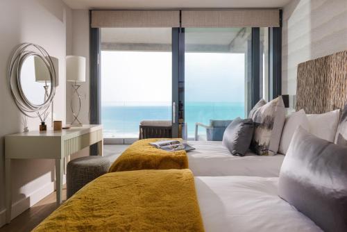 a bedroom with a large bed with a large window at St Michaels The Liner in Falmouth