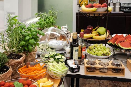 a table topped with lots of fruits and vegetables at Hotel Villa Pannonia in Venice-Lido