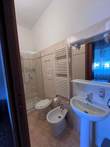 a bathroom with a sink and a toilet at ViaVai Pisa Airport in Pisa