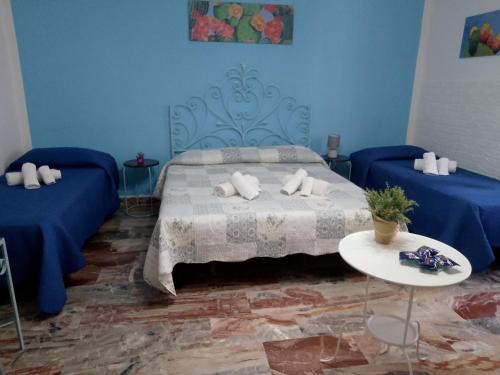a blue bedroom with a bed with pillows on it at Scilla A Vinedda in Scilla