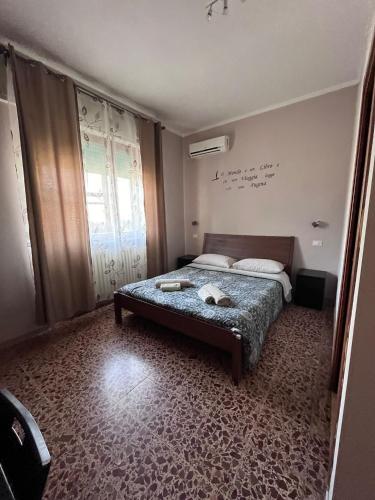 a small bedroom with a bed and a window at ViaVai Pisa Airport in Pisa