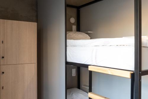 a bedroom with a bunk bed and a closet at Athens Hawks Urban in Athens