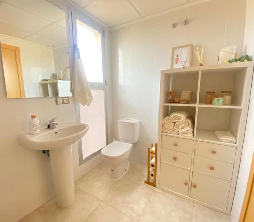 a white bathroom with a sink and a toilet at Casa Roberto - Golf y relax in San Jorge