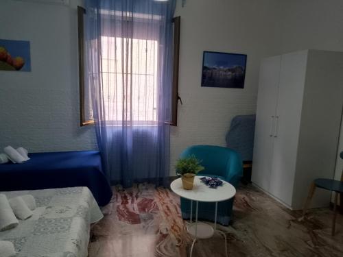 a living room with a blue couch and a table at Scilla A Vinedda in Scilla
