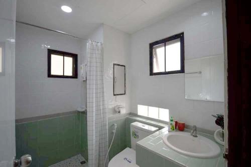 a bathroom with a sink and a toilet and a shower at 57 Hidden House BKK Chinatown in Bangkok