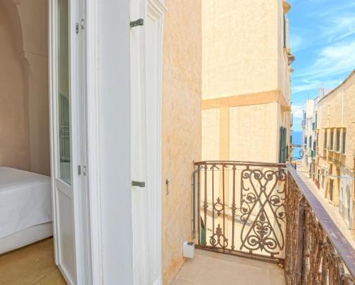 a room with a balcony with a bed at Pascaraymondo Suite Palace in Gallipoli