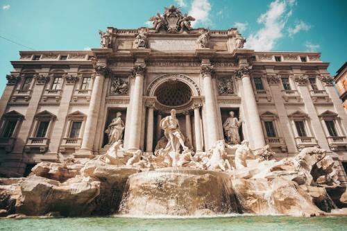 a view of the trevi fountain in front of a building at Ostello Bello Roma Colosseo in Rome