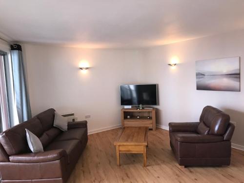 a living room with a couch and a flat screen tv at California Building in London