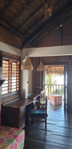 a living room with a table and chairs and a couch at Lodge Villa MAYANKI in Dzamandzar