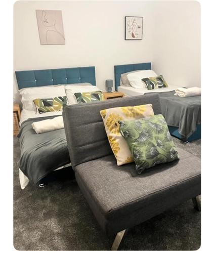 a living room with a couch and two beds at The Hideout in Trearddur