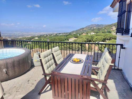 a balcony with a table and chairs and a tub at Buena Vista in Alhaurín de la Torre