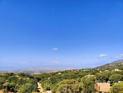 a view of a city from a hill with trees at Buena Vista in Alhaurín de la Torre