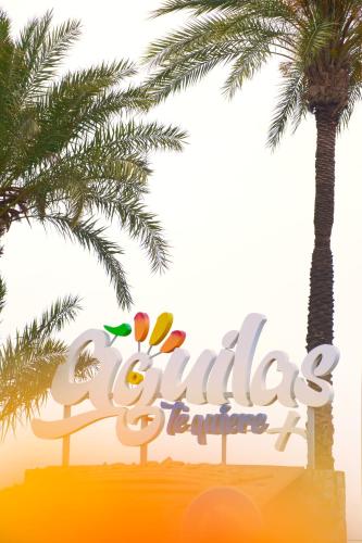 a sign for the los angeles zoo with a palm tree at Maxcaly Playa in Águilas