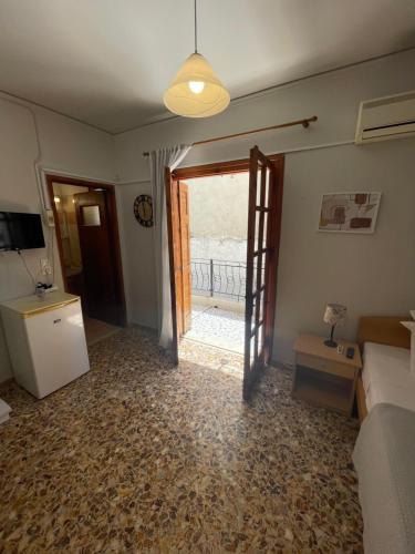 a living room with a door open to a balcony at The Beehive 2 in Mytilini