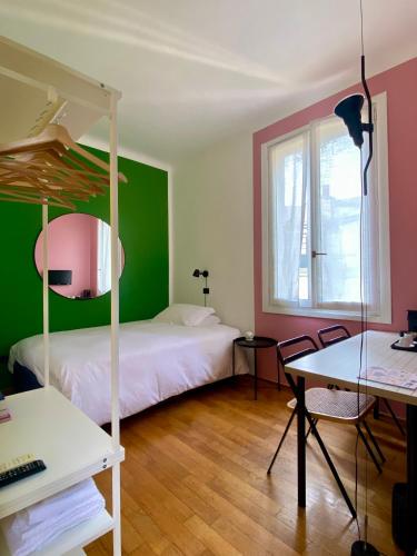 una camera da letto con due letti, una scrivania e un tavolo di Studio-Majno a Milano