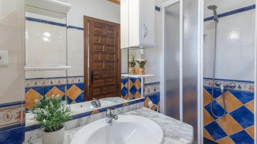 a bathroom with a sink and a mirror at Casa Tere Antequera - La Higuera by Ruralidays in Antequera