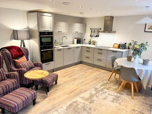 a kitchen and dining room with a table and chairs at Cottage - Sleeps 2 - Garden in Coleford