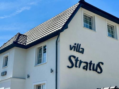 a white building with the words wills stratus on it at Villa Stratus in Gdańsk