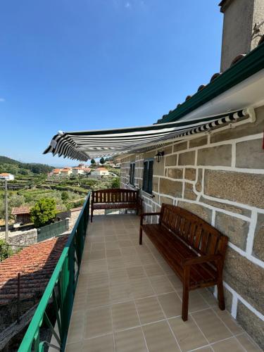 two benches on the balcony of a house at Casa do Terreiro in São João de Tarouca