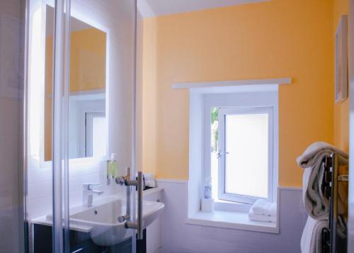 a bathroom with a sink and a mirror at Gresham Court in Torquay