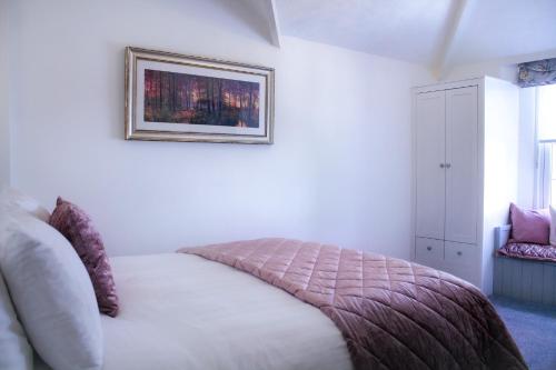 a bedroom with a bed and a picture on the wall at Gresham Court in Torquay